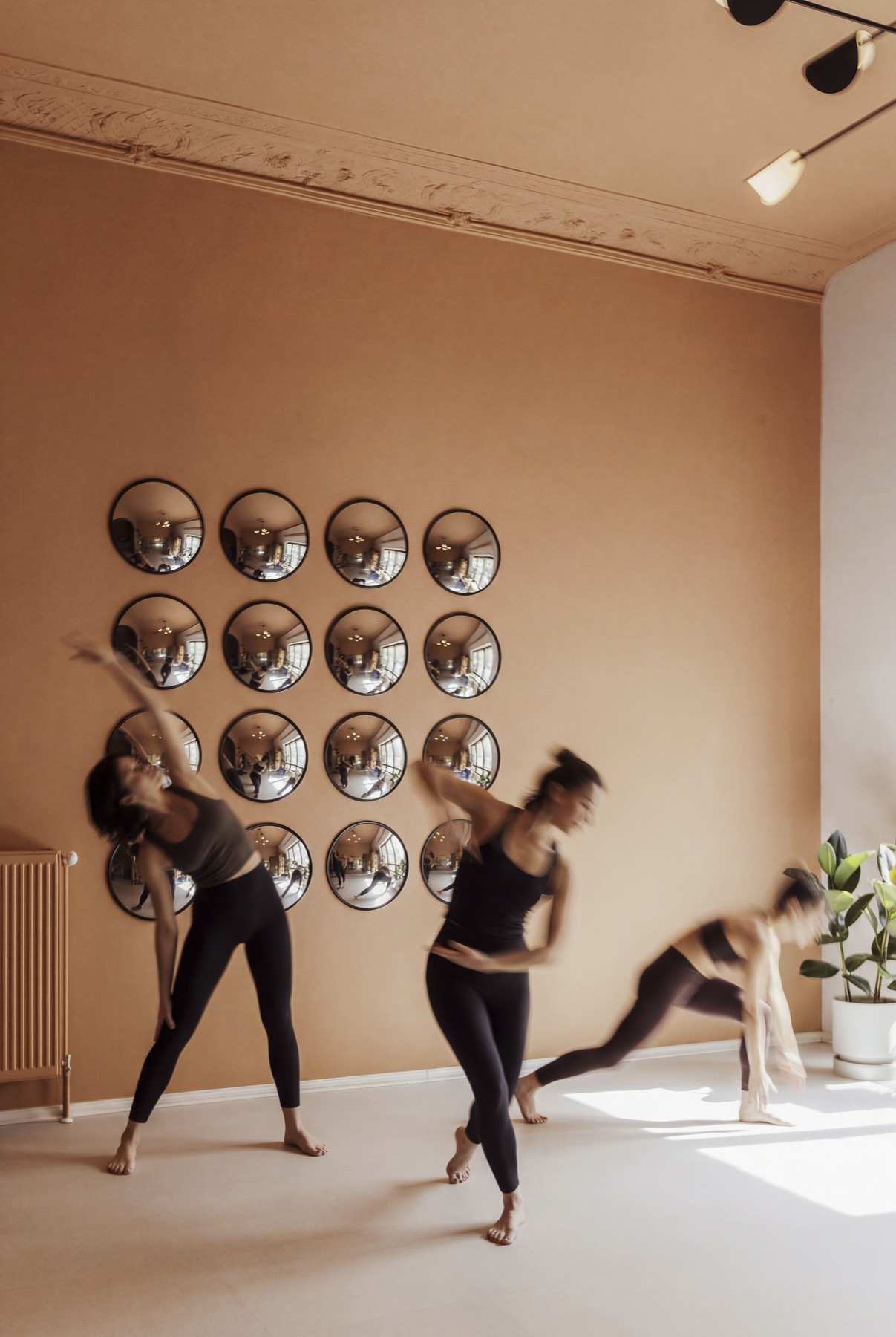 Members moving in front of the mirror wall